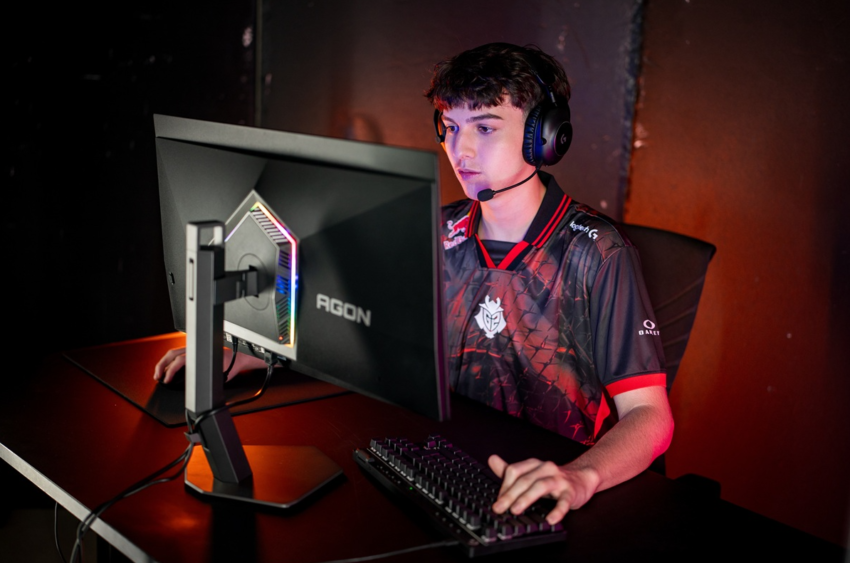 A person wearing headphones and a headset sitting at a computer AI-generated content may be incorrect.